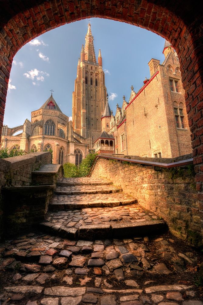An arch leads to a church in Bruges-Belgium